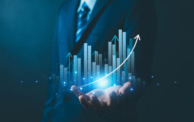 Businesspeople hold a digital hologram of an icon, a digital bar graph, and an upward-sloping curve, symbolizing increasing profits, sales, or market value.