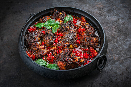 Traditional authentic Persian khoresh fesenjan - chicken stew with walnut and pomegranate sauce