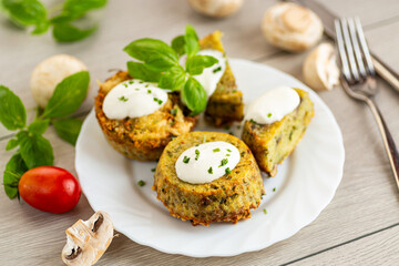 Baked potato cakes with mushrooms and fresh herbs on plate
