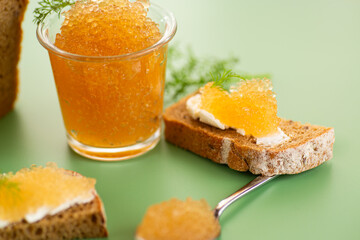 Golden caviar served on bread with butter in elegant food composition
