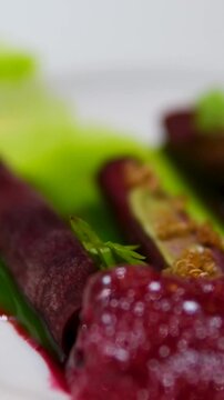 Close-up molecular beet foam dish on Virgin Voyages Test Kitchen served aboard Scarlet Lady artistic plating vibrant beet foam culinary experimental dining cruise ship fine cuisine