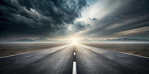 A long, straight highway stretches towards a radiant sunrise beyond a hazy, flat landscape under a dramatic sky