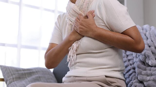 Elderly woman experiencing severe chest pain and heart attack.