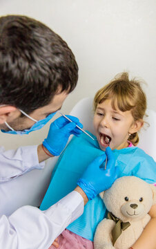 A child at the dentist gets his teeth treated. Selective focus.