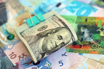 Kuwaiti dinar currency money bills and bunch of us dollar banknotes close up. The concept of economics and currency exchange