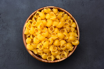 Raw pipe rigate pasta on black background