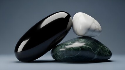 Three polished stones in black, white, and green arranged elegantly