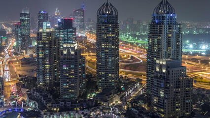 Fototapeta premium Aerial top view of Dubai Marina day to night timelapse. Modern towers and traffic on the road