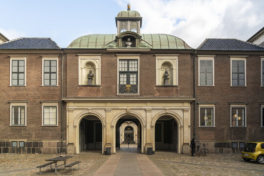 Copenhagen, Denmark - 30 September 2025: View of the stately Christiansborg Palace, its brick facade and arched entryway framing a glimpse into the inner courtyard.