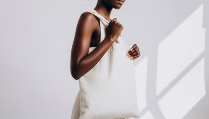 Canvas tote bag mockup worn on shoulder by person in studio light