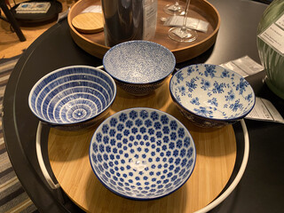 Set of four blue and white ceramic bowls with floral and geometric patterns