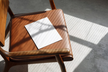 Blank flyerr mockup on leather chair with natural light shadows