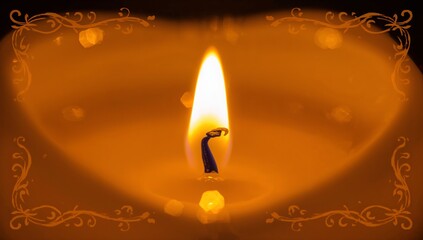 Flickering single lit candle showing teardrop flame and charred wick on flat surface, hexagon bokeh