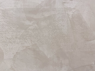 Textured beige wall with subtle patterns and rough surface details in abstract style