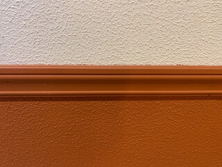 Two-tone textured wall with wooden molding divider