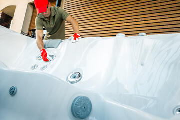 Man Cleans Hot Tub at a Home in Bright Afternoon Light