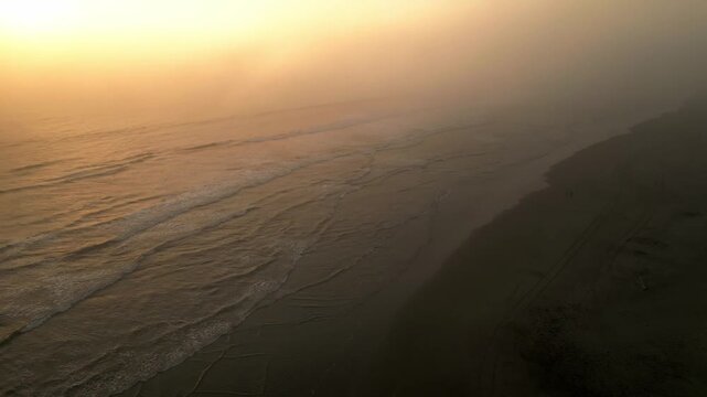 Aerial Summer Sunset at Puerto Eten, Chiclayo, Lambayeque, Golden Sandy Beach and Calm Pacific Ocean, Ideal Tropical Coastal Destination