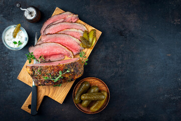 Traditional Commonwealth Sunday roast with sliced cold cuts roast beef with with cornichon pickle and relish remoulade sauce