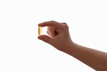 Vimamin D3 Omega Capsule for Children. Omega-3 d3 in Child Hand Isolated on White Background. Kids...