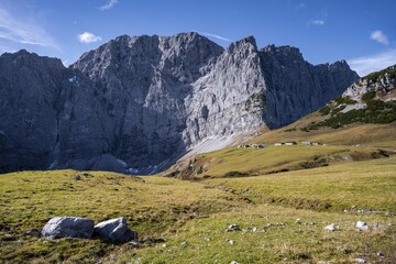 Dreizinkenspitze and Laliederer Wand, large rock face with meadows in the foreground under blue sky, eastern Karwendel, Tyrol, Austria