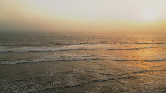 Aerial Summer Sunset at Puerto Eten, Chiclayo, Lambayeque, Golden Sandy Beach and Calm Pacific Ocean, Ideal Tropical Coastal Destination