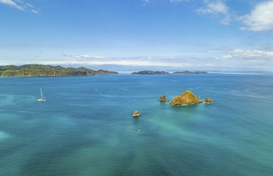 Aerial view, tropical islands and sailing boat in the turquoise ocean, Tortuga Island, Puntarenas, Costa Rica