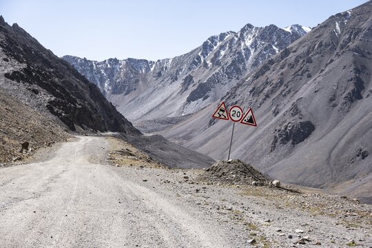 Warning sign at the mountain pass, Dangerous gravel road in the mountains in the Tien Shan, Engilchek Valley, Kyrgyzstan, Issyk Kul, Kyrgyzstan