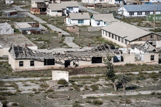 Abandoned buildings in a barren landscape, ghost town of Enilchek in the Tien Shan Mountains, Ak-Su, Kyrgyzstan