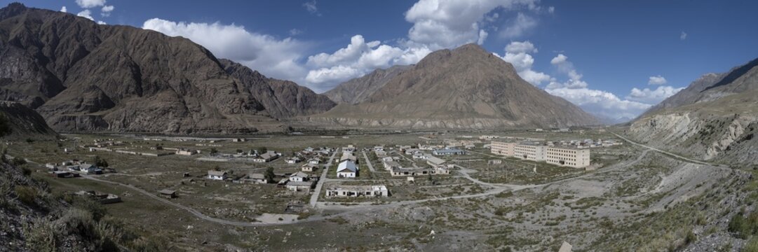 Town view, Abandoned buildings in barren landscape, Ghost town Enilchek in the Tien Shan Mountains, Ak-Su, Kyrgyzstan