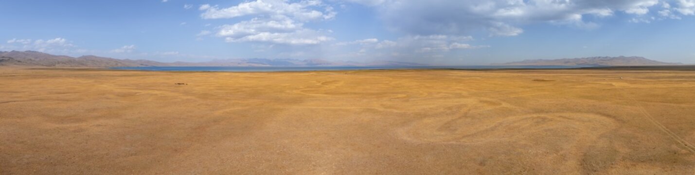 Aerial view, Vast empty landscape at the mountain lake Song Kul in autumn, Moldo Too Mountains, Naryn region, Kyrgyzstan