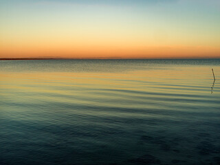 Landscape with the winter sea and the colors of the sunset