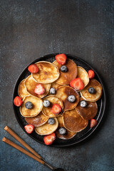 Mini pancakes with blueberries and strawberries