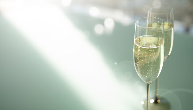 Two elegant champagne glasses filled with sparkling wine and bright blurred bokeh lights in modern setting. Background for sophisticated celebrations. Close-up with space for text.