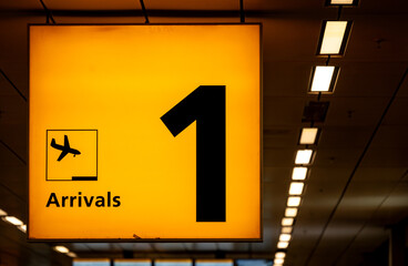 Airport Sign With Airplane Arrival Icon on Yellow Background