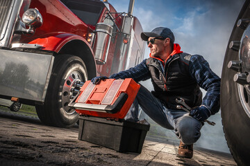 Mechanic Repairs Semi Truck by the Roadside in Early Morning