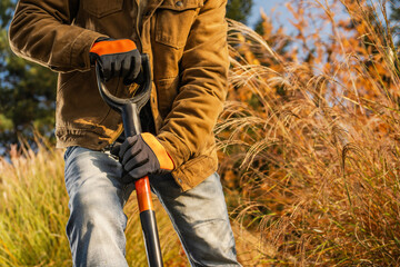 Man Digging in Garden During Sunny Afternoon