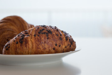 Cornetti al cioccolato e classico su piatto bianco
