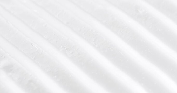 Cosmetic smears of creamy texture. Cosmetic skin cream. Beauty skincare product sample. Close-up footage of cream texture on rotating table