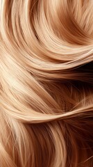 Fototapeta premium Close up of flowing blonde and brown hair strands creating a wave pattern with light reflections.