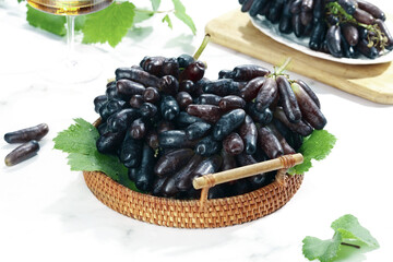 Fresh Seedless Dark Grapes in Basket with Wine and Garnish