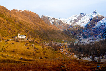 Landscape with a church in the mountains in winter, Lecco, Italy