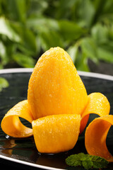 Fresh Peeled Mango Cut Into Segments with Water Droplets
