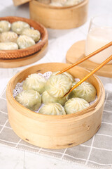 Steamed Scallion Buns in Bamboo Baskets with Chopsticks