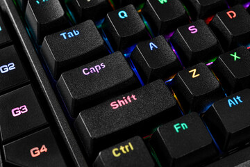 Macro close-up of mechanical gaming keyboard keys with vibrant RGB backlight.