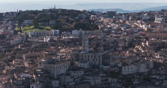 Aerial view of the ancient city of Matera presents a stunning display of tightly packed buildings with a dominant church tower, Matera, Basilicata, Italy.
