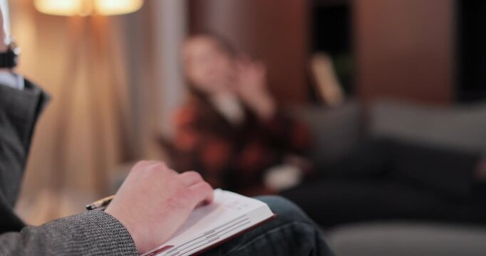 Young woman patient lying on crouch release emotion from traumatic event, anxiety or mental illness to psychiatrist during mental treatment therapy in office. Psychological consultation session.