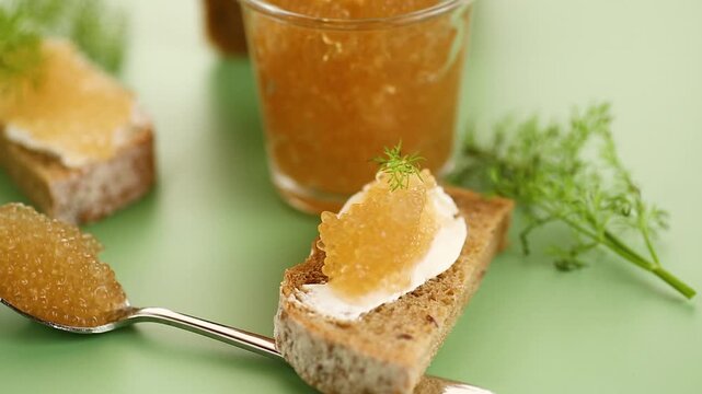 Golden caviar served on bread with butter in elegant food composition