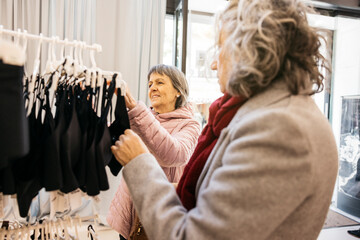 Senior women shopping together at retail clothing store