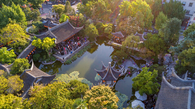 Aerial view of traditional Chinese architecture reflecting in a serene pond at Lan Su Chinese Garden, Portland, Oregon, United States.