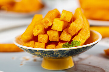 Golden Crispy Potato Crisps in Decorative Bowl